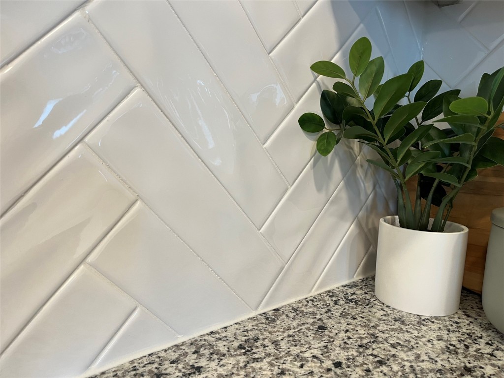 8506 Wellspring Loop Round Rock, TX 78665 - Photo 6 of 33 Kitchen upgraded herringbone pattern backsplash with granite countertops