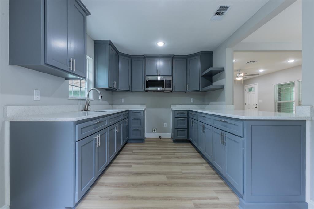 2816 Summer Avenue Waco, TX 76708 - Photo 6 of 16 a kitchen with kitchen island granite countertop a sink and cabinets