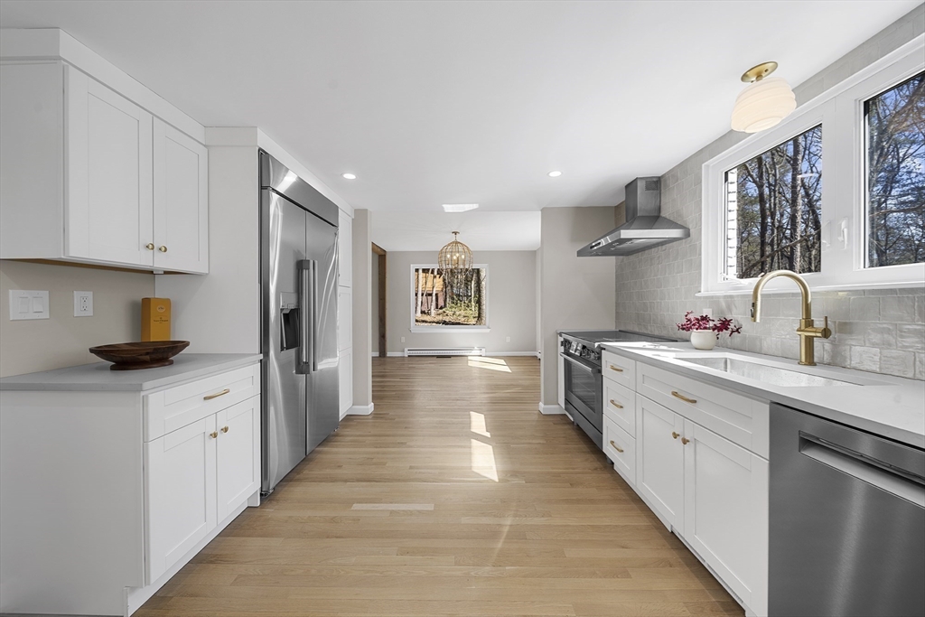 4 Fox Run Road Bedford, MA 01730 - Photo 13 of 42 a large kitchen with stainless steel appliances a sink stove and cabinets