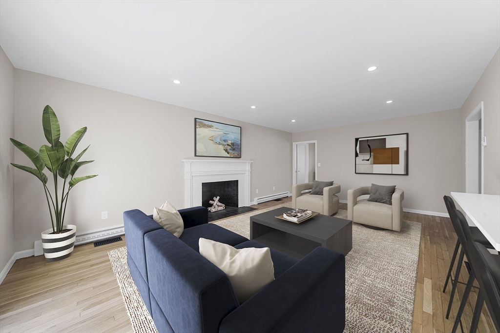4 Fox Run Road Bedford, MA 01730 - Photo 14 of 42 a living room with furniture a fireplace and a potted plant