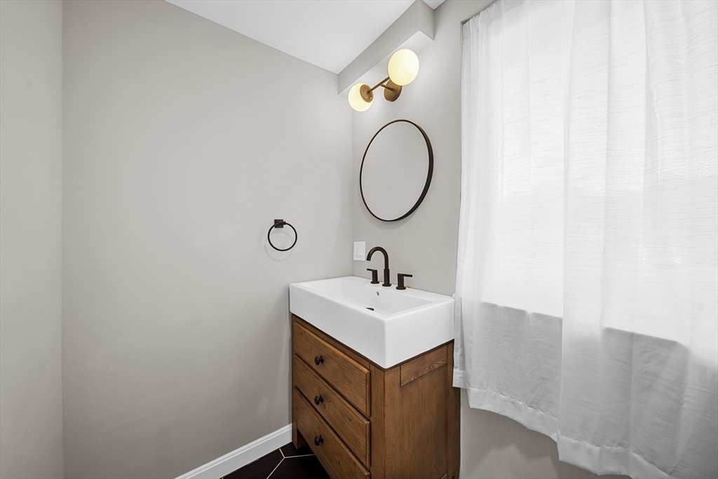 4 Fox Run Road Bedford, MA 01730 - Photo 18 of 42 a bathroom with a sink and a mirror