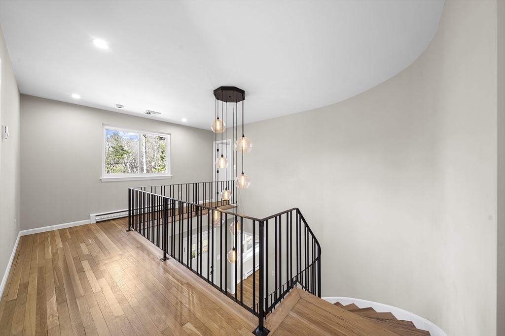 4 Fox Run Road Bedford, MA 01730 - Photo 20 of 42 a view of a hallway with wooden floor and iron gate