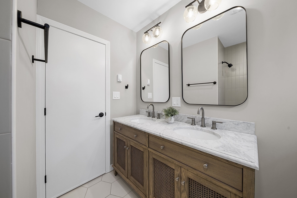 4 Fox Run Road Bedford, MA 01730 - Photo 21 of 42 a bathroom with a double vanity sink and mirror