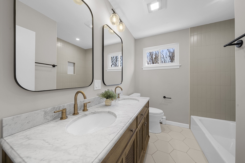 4 Fox Run Road Bedford, MA 01730 - Photo 22 of 42 a bathroom with a granite countertop sink mirror vanity and toilet