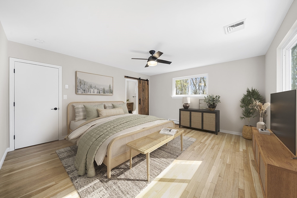 4 Fox Run Road Bedford, MA 01730 - Photo 23 of 42 a spacious bedroom with a bed and a flat tv screen on dresser