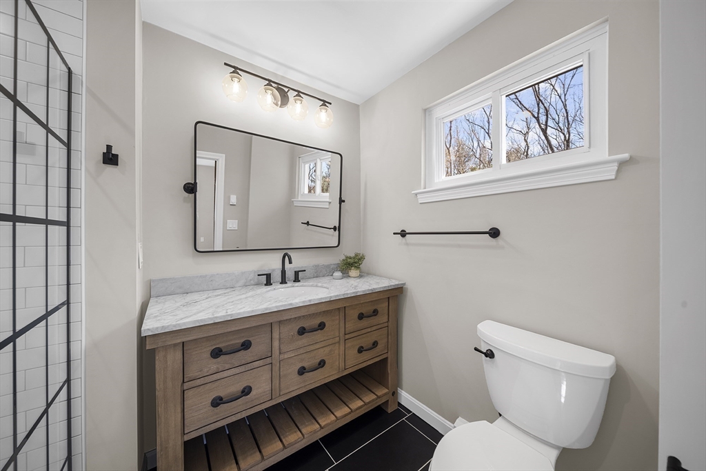 4 Fox Run Road Bedford, MA 01730 - Photo 25 of 42 a bathroom with a toilet a sink and mirror
