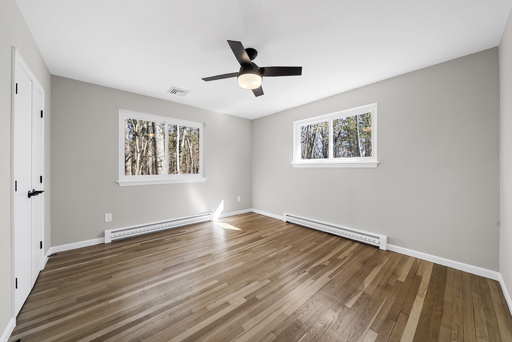 4 Fox Run Road Bedford, MA 01730 - Photo 27 of 42 a view of an empty room with wooden floor and a window