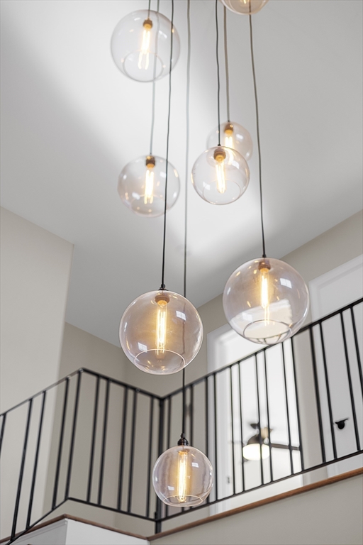 4 Fox Run Road Bedford, MA 01730 - Photo 28 of 42 a view of staircase with a chandelier fan and wooden floor