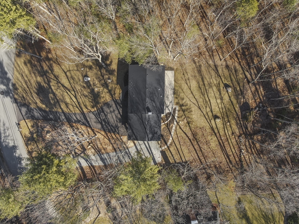 4 Fox Run Road Bedford, MA 01730 - Photo 41 of 42 a backyard of a building with large trees