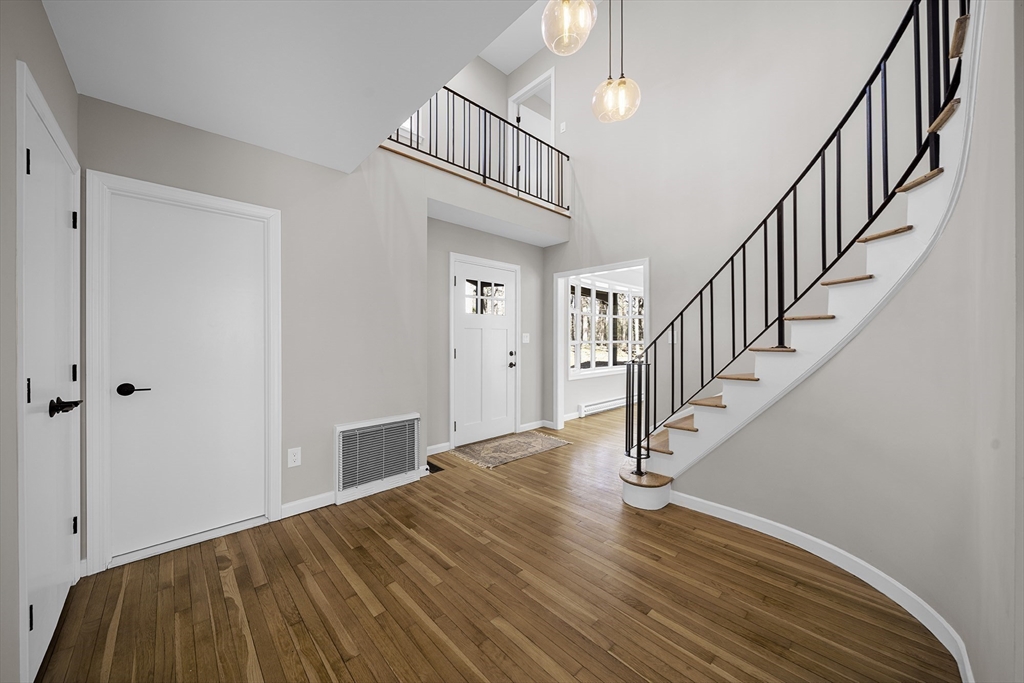 4 Fox Run Road Bedford, MA 01730 - Photo 5 of 42 a view of staircase with wooden floor and a rug