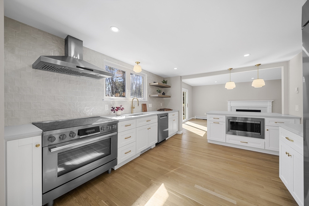 4 Fox Run Road Bedford, MA 01730 - Photo 7 of 42 a kitchen with stainless steel appliances a stove a sink and white cabinets