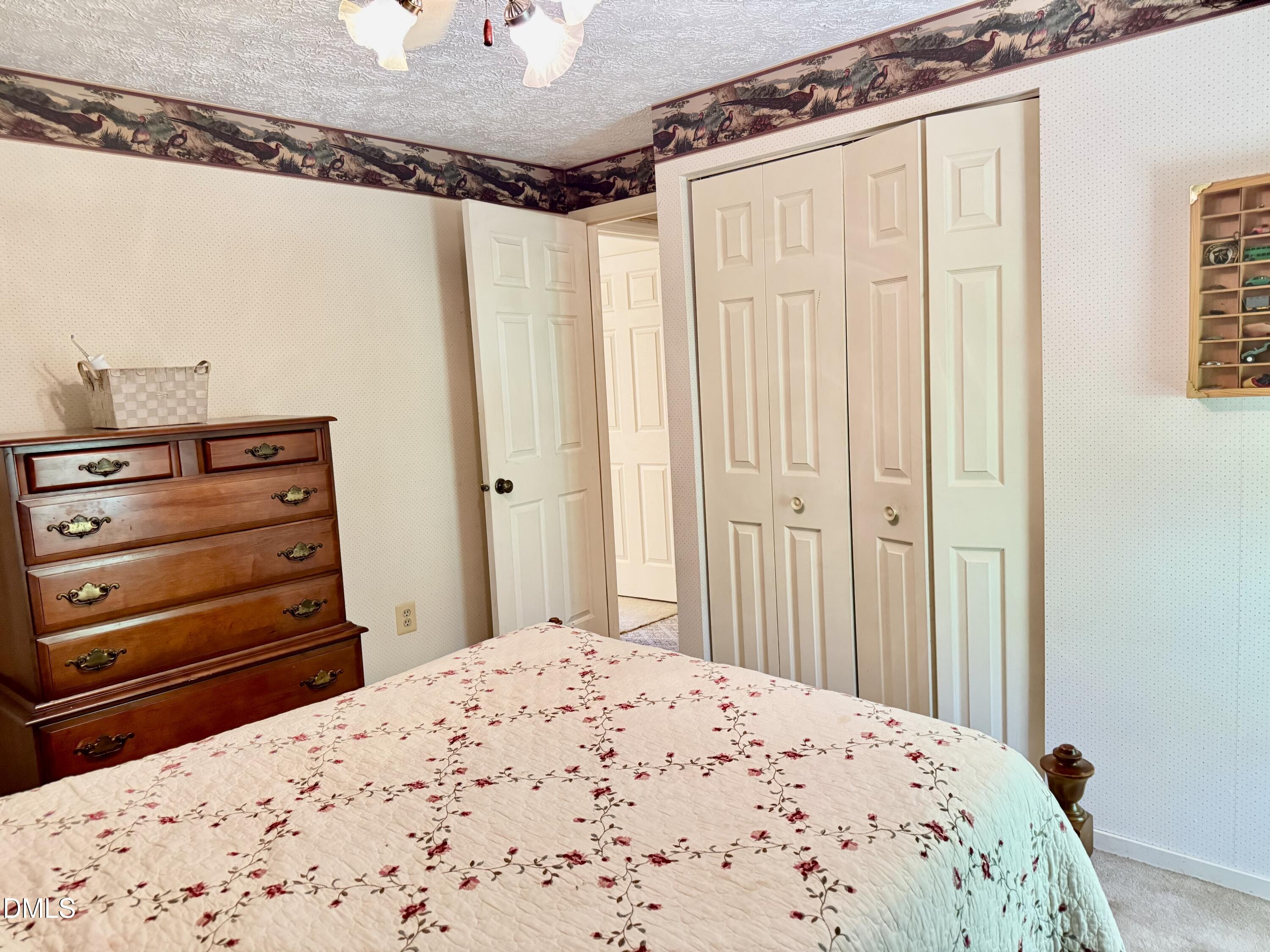 84 Wintergreen Road Henderson, NC 27537 - Photo 30 of 49 a bedroom with a bed and a dresser