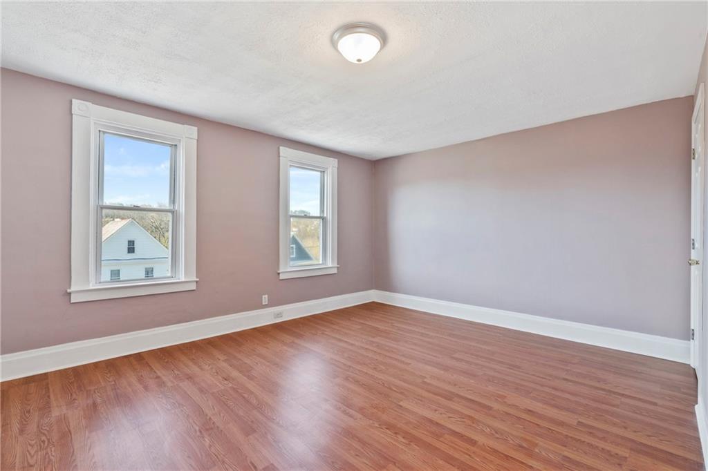 711 9th Avenue Irwin, PA 15642 - Photo 18 of 26 an empty room with wooden floor and windows