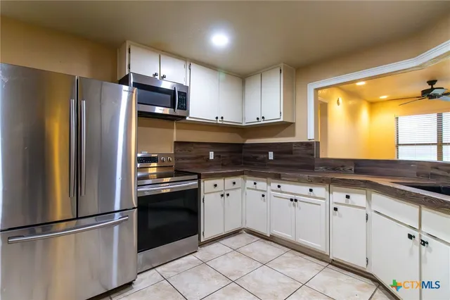 a kitchen with granite countertop stainless steel appliances and sink