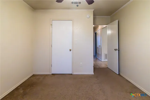 a bathroom with a toilet a sink a mirror and a window