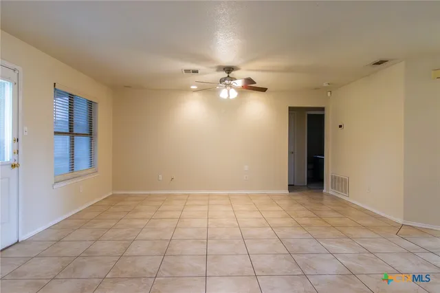 a view of an empty room with a window