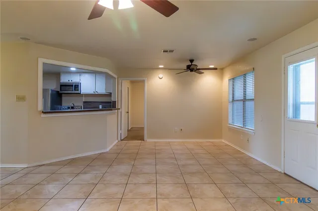 a view of a kitchen with a sink and cabinets