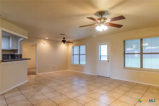 a view of an empty room with a window