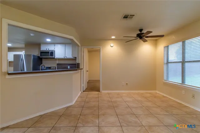 a view of a kitchen with a sink and cabinets