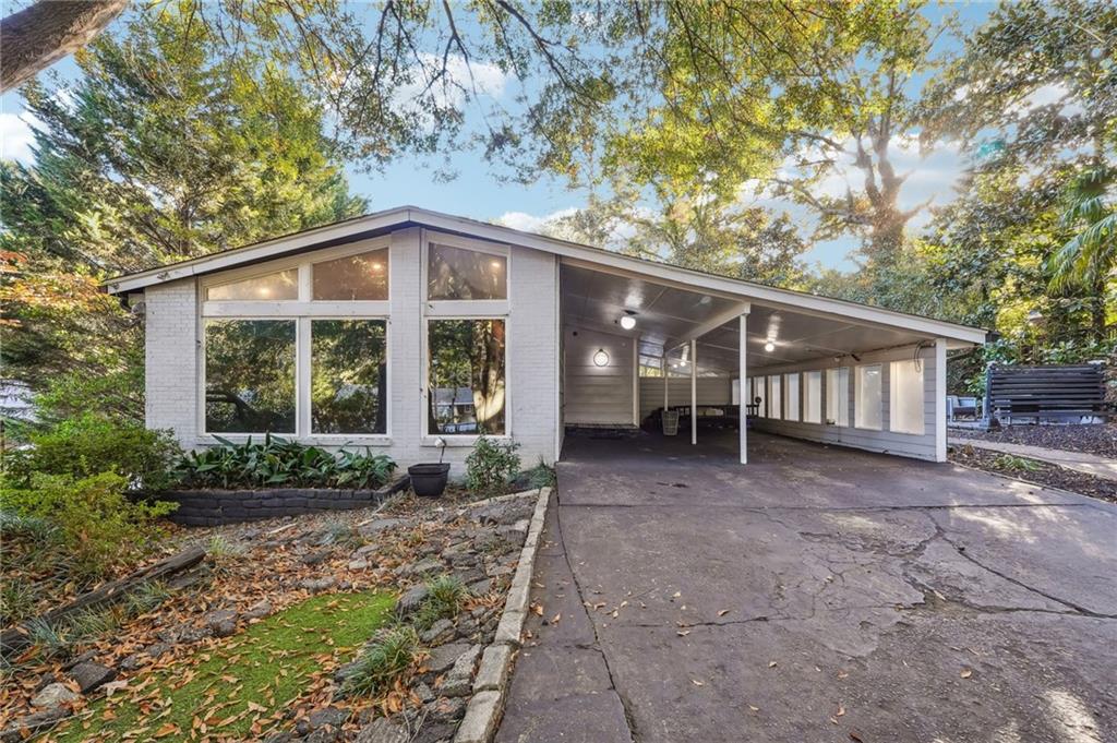 a view of a house with a yard and plants
