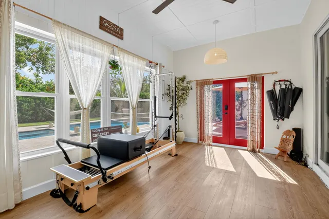 a bedroom with a bed and painting on the wall
