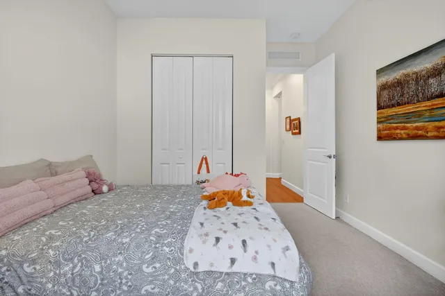a bathroom with a granite countertop sink a toilet and a mirror
