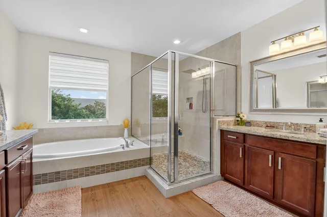 a spacious bathroom with a tub shower and sink