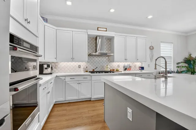 a view of kitchen with refrigerator and wooden floor