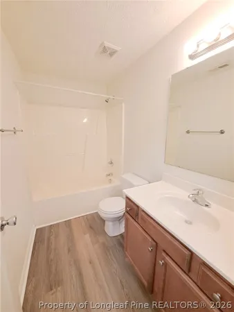a bathroom with a sink a toilet and a large mirror