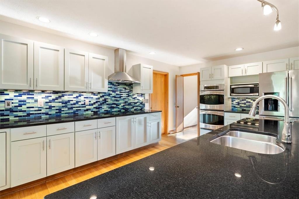 3 Partridge Court Sewickley, PA 15143 - Photo 16 of 50 a kitchen with stainless steel appliances a sink stove and white cabinets