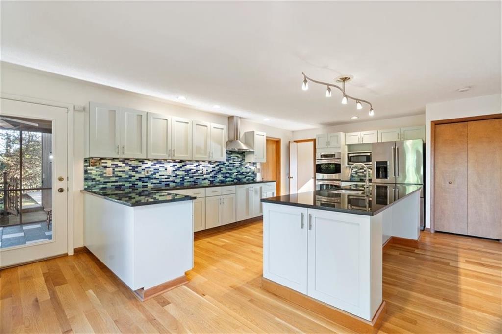 3 Partridge Court Sewickley, PA 15143 - Photo 17 of 50 a kitchen with stainless steel appliances kitchen island granite countertop white cabinets and wooden floor