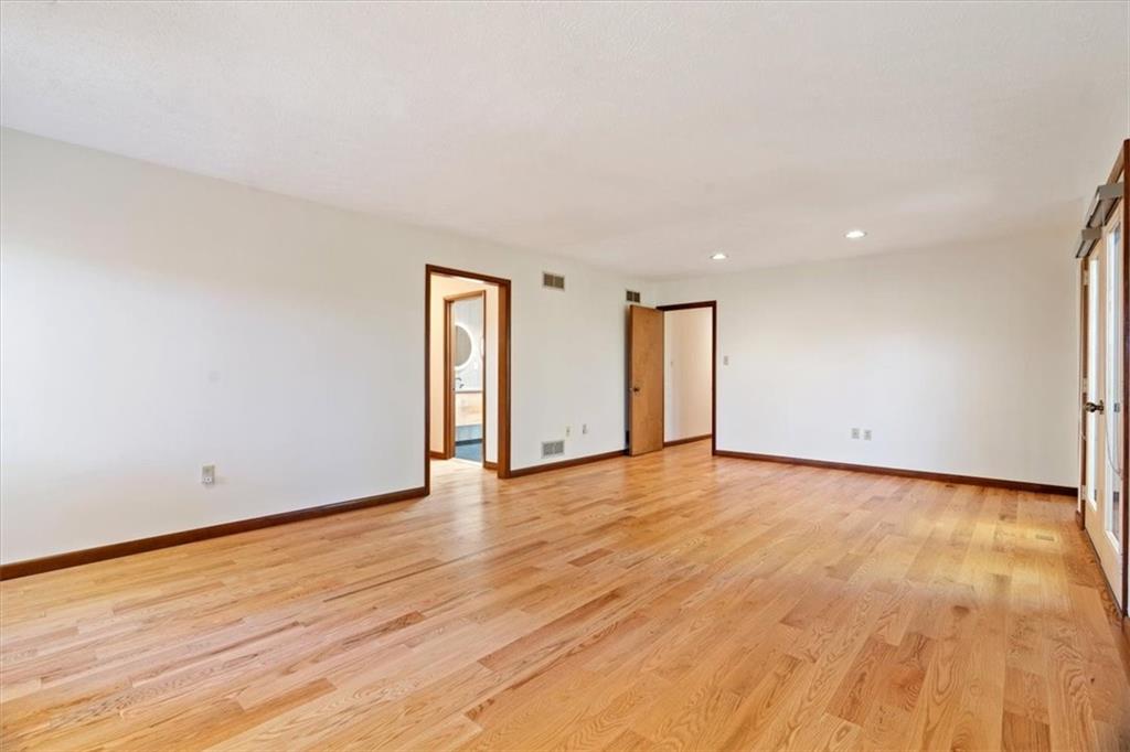 3 Partridge Court Sewickley, PA 15143 - Photo 23 of 50 a view of an empty room with wooden floor and closet