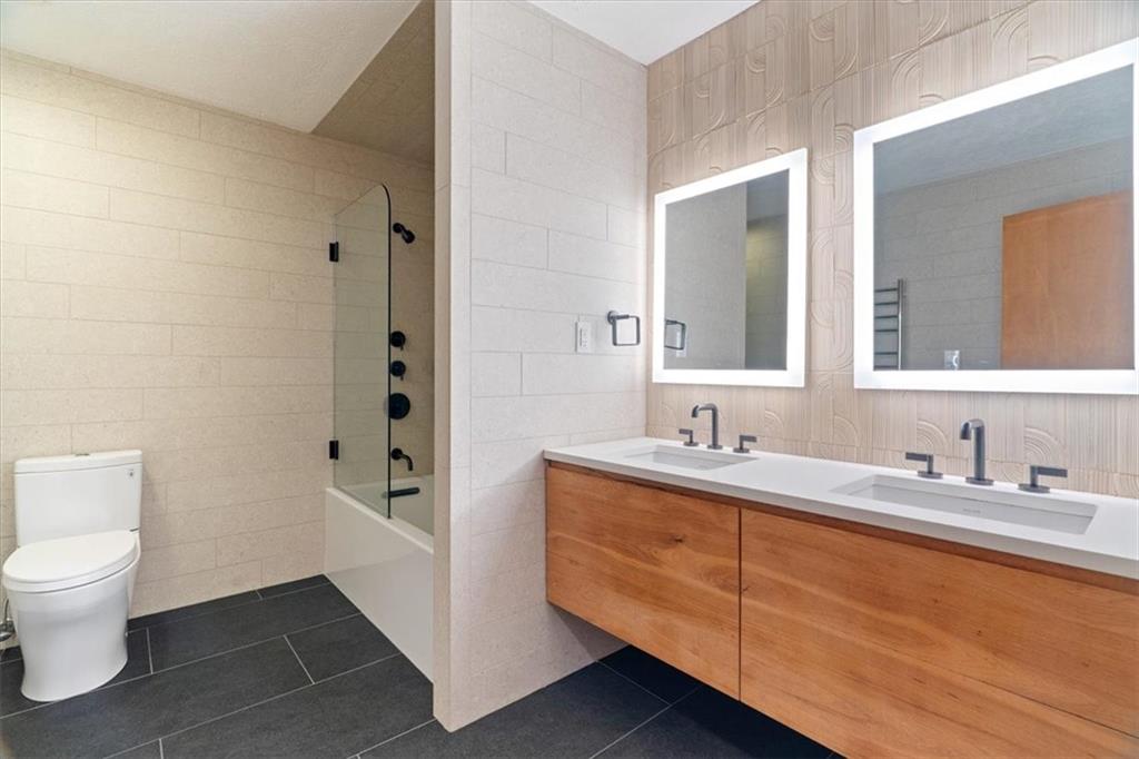 3 Partridge Court Sewickley, PA 15143 - Photo 32 of 50 a bathroom with a granite countertop sink toilet and mirror