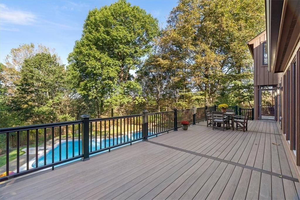 3 Partridge Court Sewickley, PA 15143 - Photo 41 of 50 a view of a patio with dining table and chairs with wooden floor and fence
