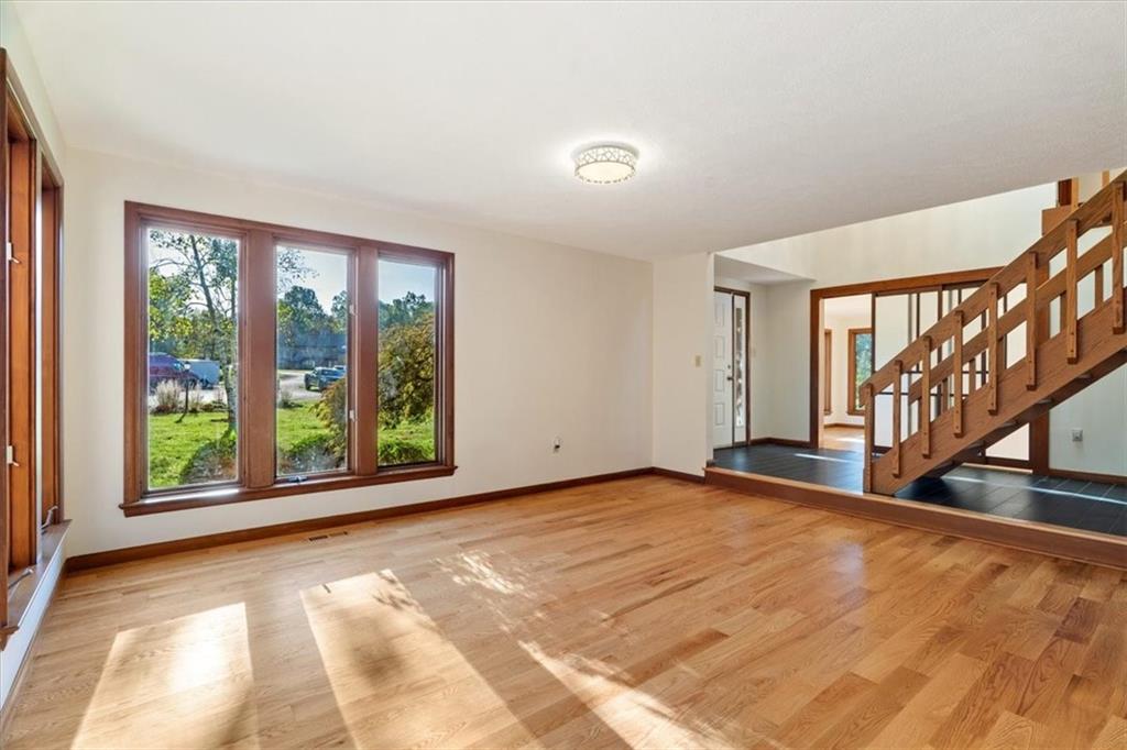 3 Partridge Court Sewickley, PA 15143 - Photo 8 of 50 a view of an empty room with wooden floor and a window