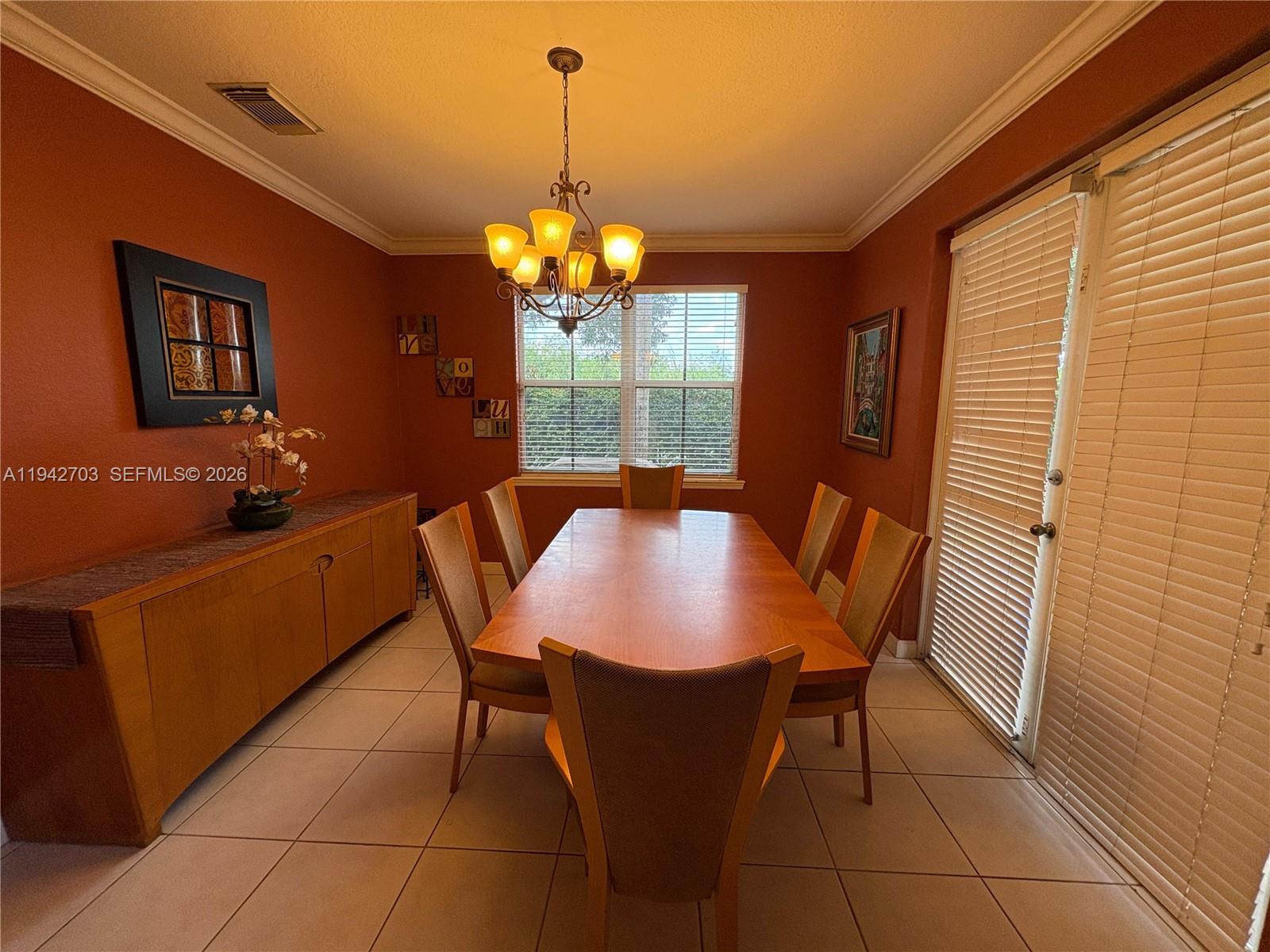 5902 Southwest 166th Court Miami, FL 33193 - Photo 11 of 27 a view of a dining room with furniture and chandelier