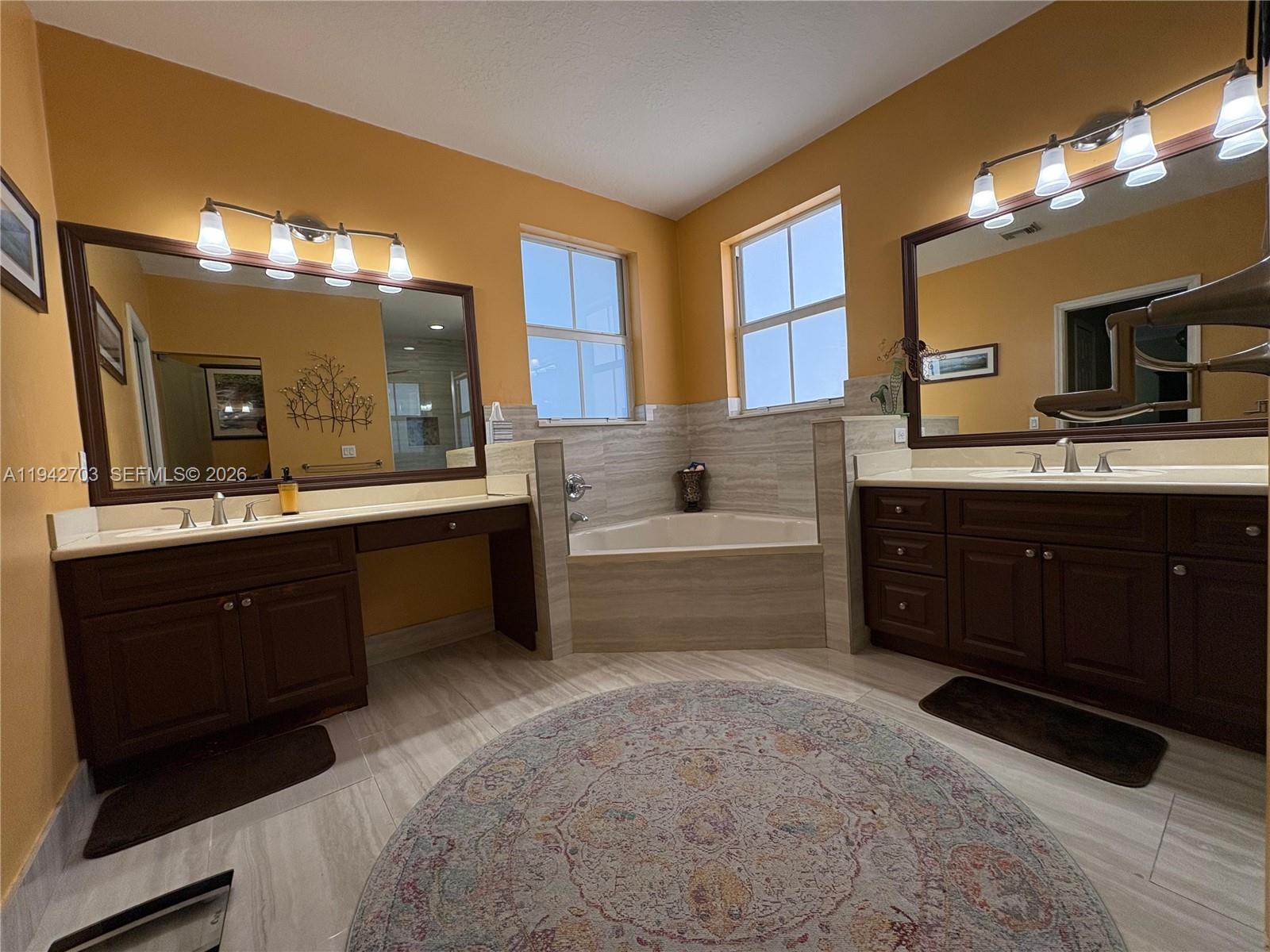 5902 Southwest 166th Court Miami, FL 33193 - Photo 14 of 27 a spacious bathroom with a tub sink and mirror
