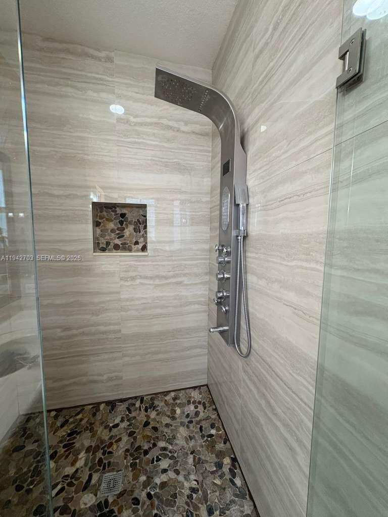 5902 Southwest 166th Court Miami, FL 33193 - Photo 16 of 27 a bathroom with a shower