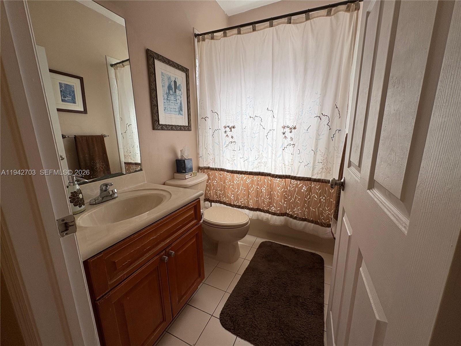 5902 Southwest 166th Court Miami, FL 33193 - Photo 23 of 27 a bathroom with a sink a toilet and mirror