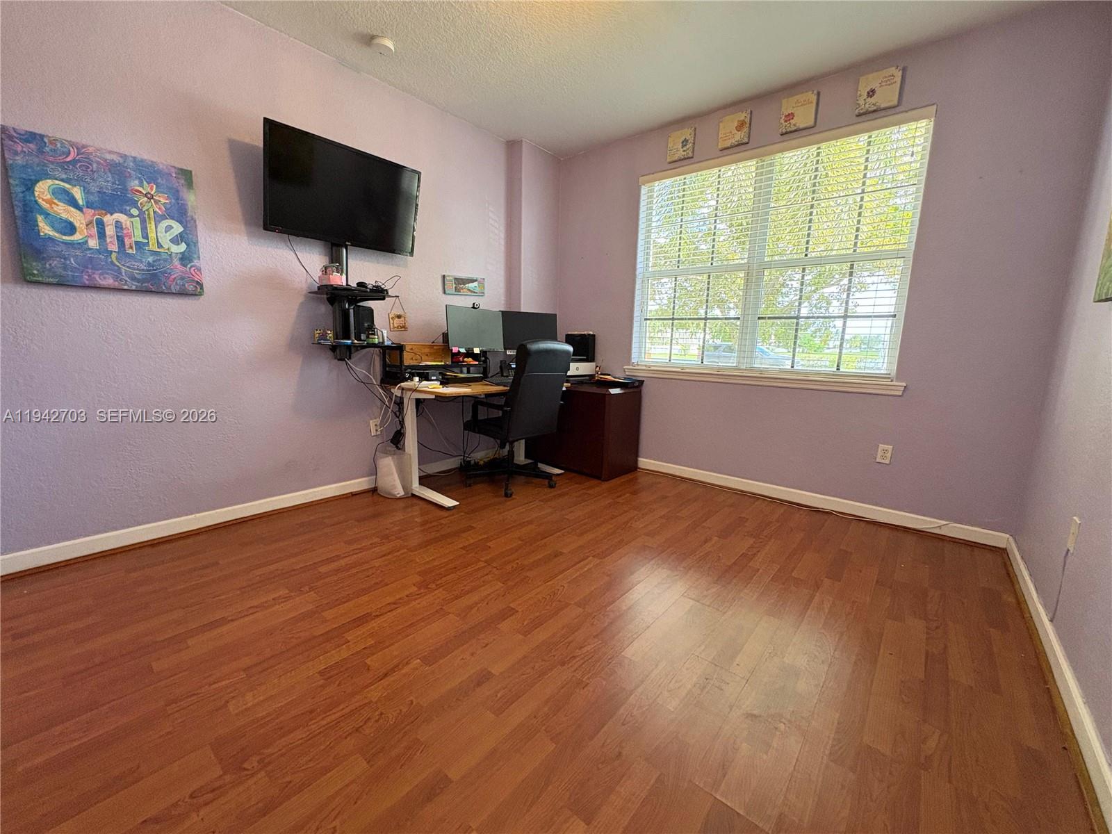 5902 Southwest 166th Court Miami, FL 33193 - Photo 25 of 27 a view of a livingroom with workspace and a window
