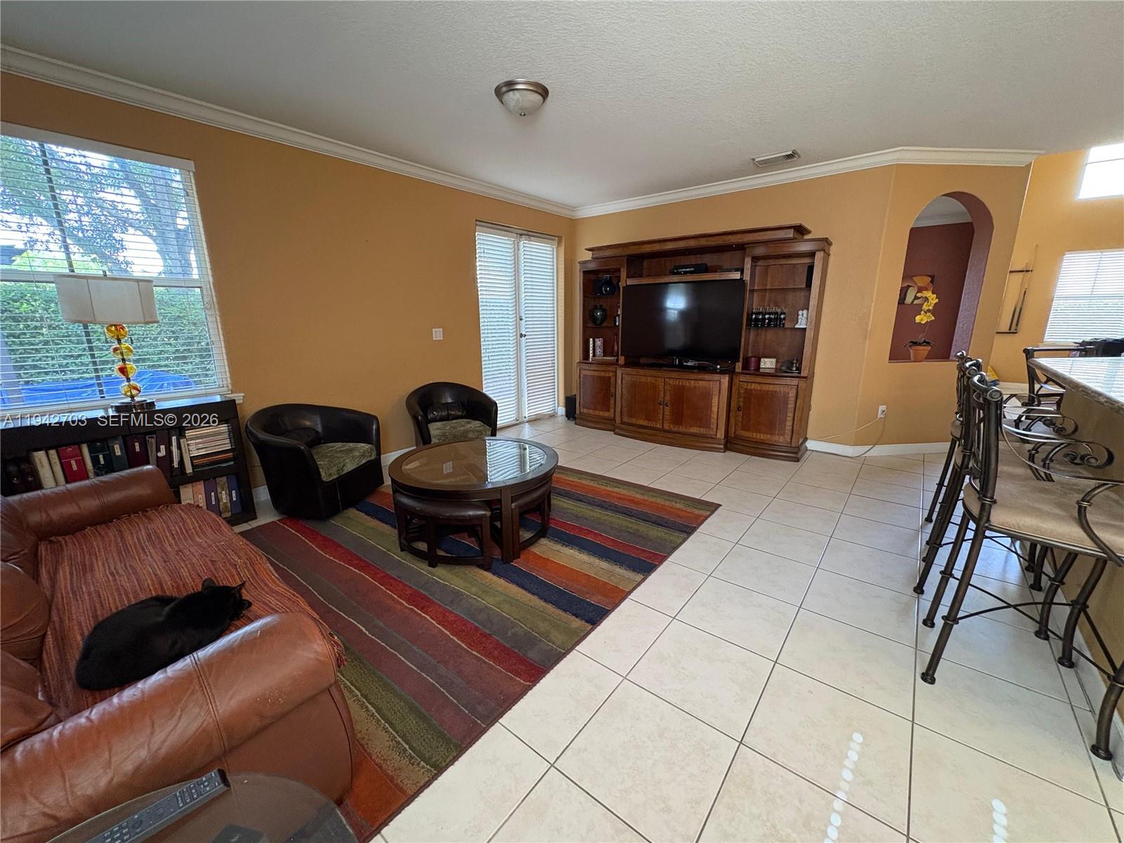 5902 Southwest 166th Court Miami, FL 33193 - Photo 10 of 27 a living room with furniture and a flat screen tv