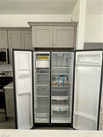 a kitchen with appliances and cabinets