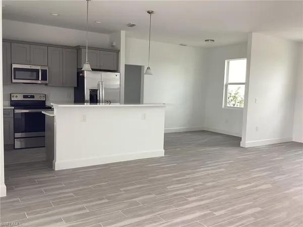 a view of a kitchen with electric appliances