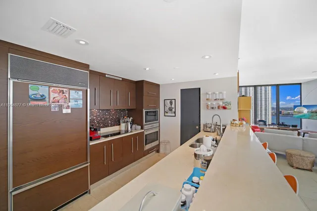 a kitchen with sink a stove and cabinets