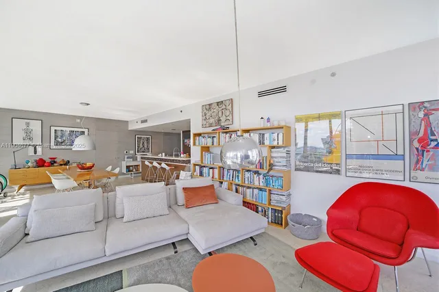 a living room with furniture and a book shelf