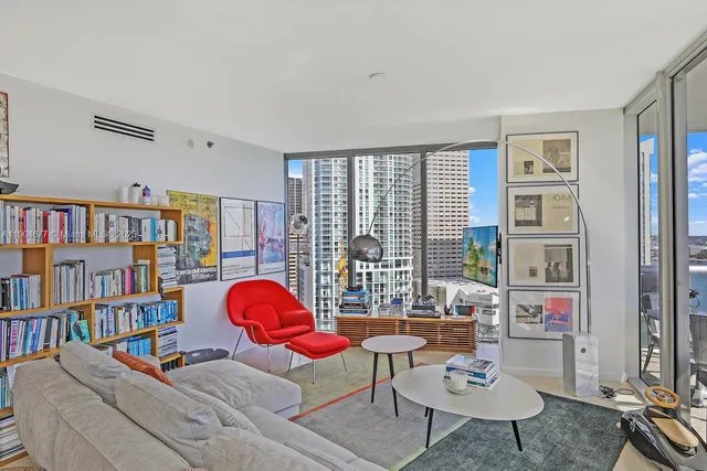 a living room with furniture a rug and a book shelf