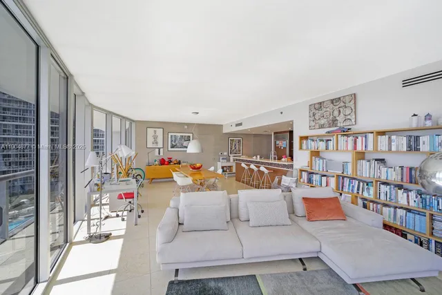 a view of a livingroom with furniture and a large window