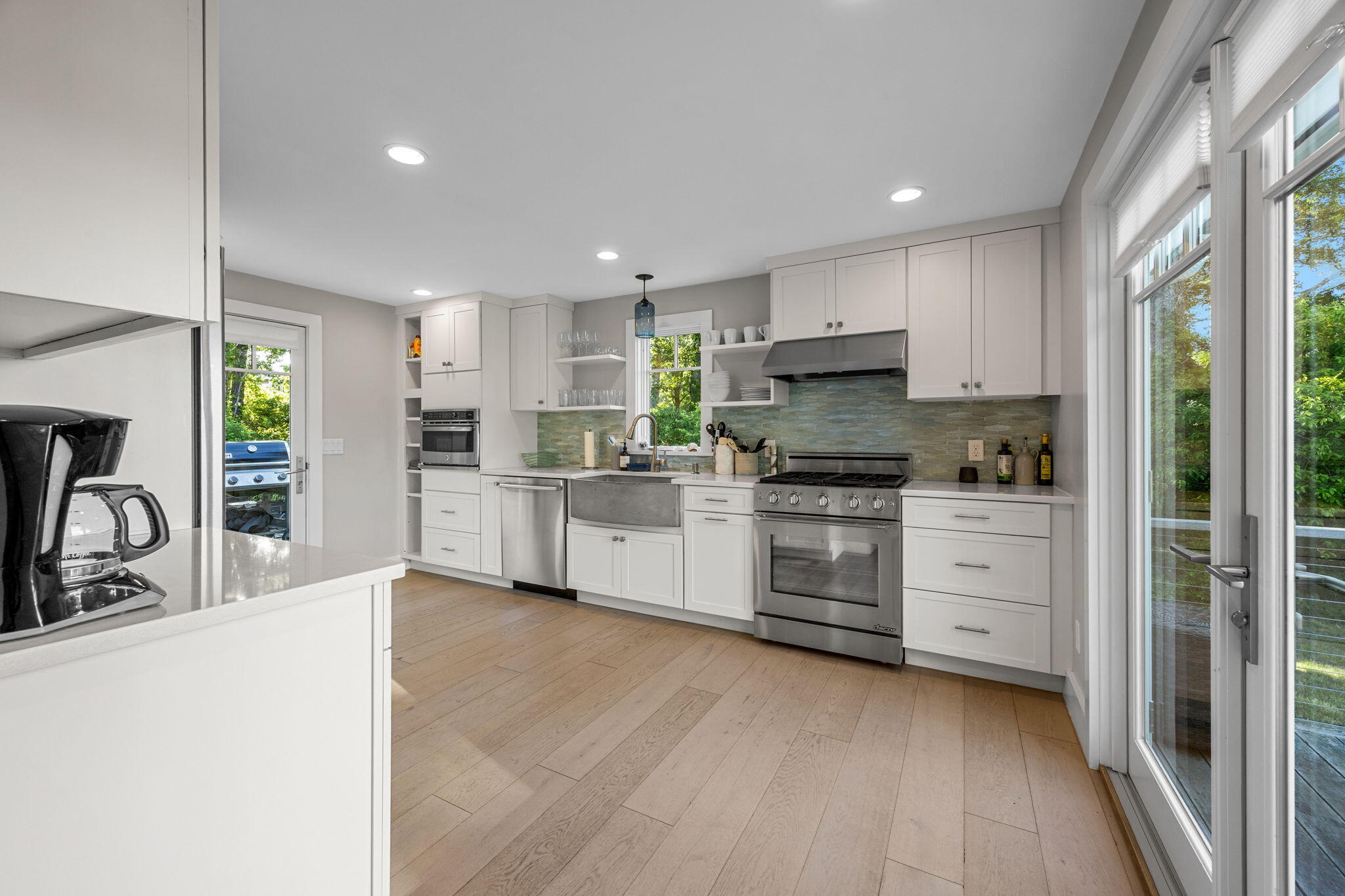 17 Bog Way Road Chatham, MA 02633 - Photo 11 of 39 a kitchen with white cabinets and stainless steel appliances