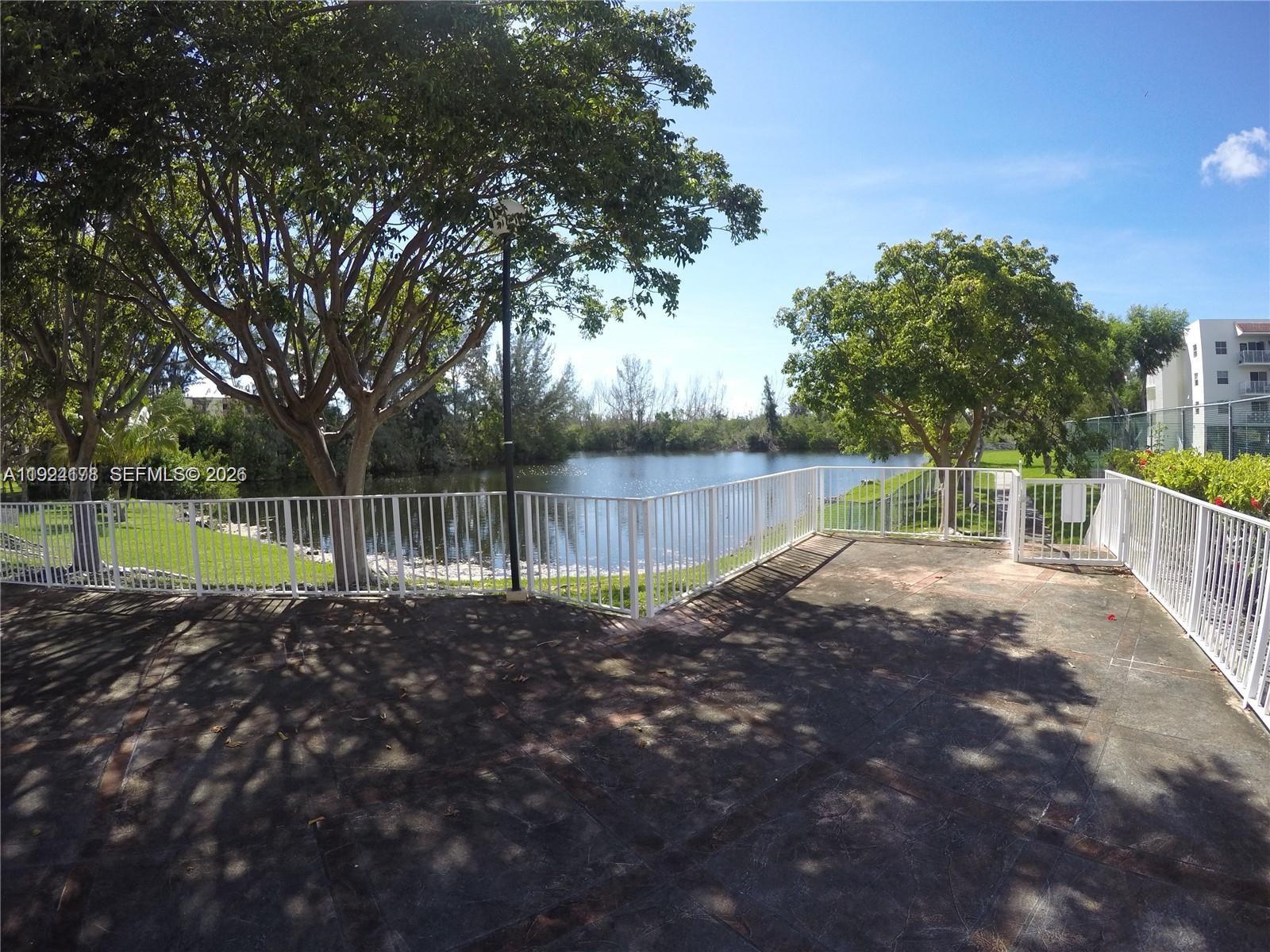 8200 Southwest 210th Street, Unit 320 Cutler Bay, FL 33189 - Photo 12 of 14 a view of a backyard with wooden fence and a large tree