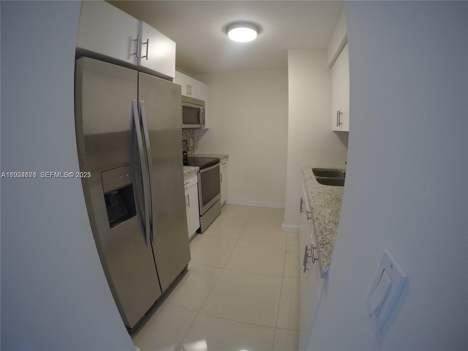 8200 Southwest 210th Street, Unit 320 Cutler Bay, FL 33189 - Photo 3 of 14 a bathroom with a shower and a mirror